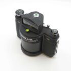 A vintage Widelux swing-lens panoramic camera with two cylindrical film holders and a central mechanism for taking wide-angle photographs.