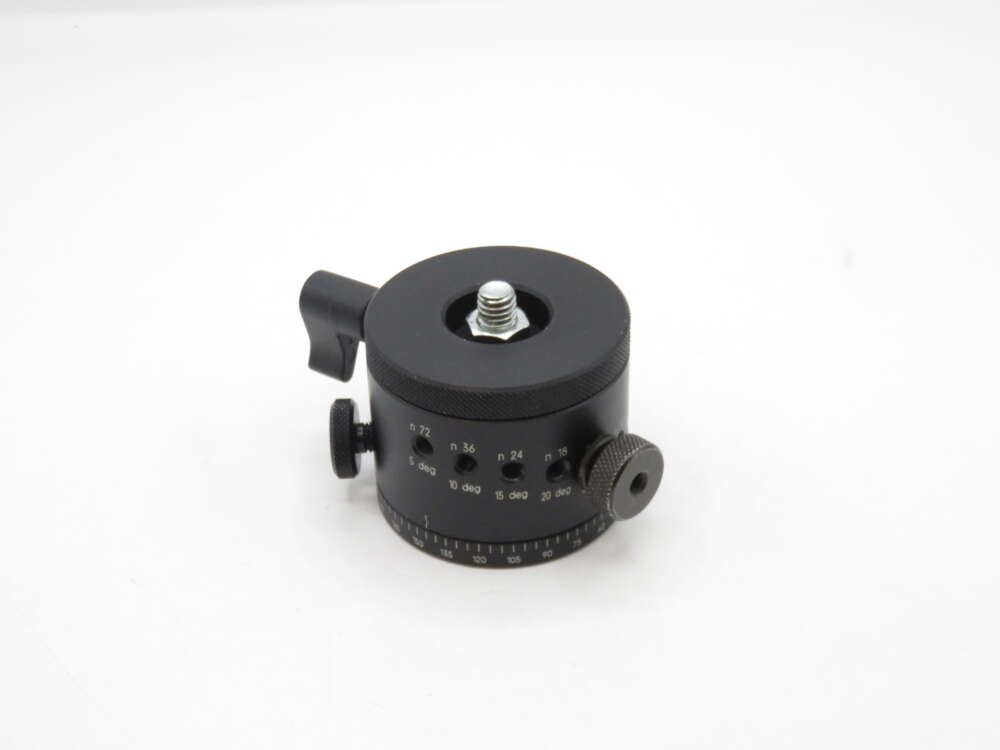 IMG_1390 A black metal camera tripod head with adjustment knobs and angle markings on its side, shown on a white background.