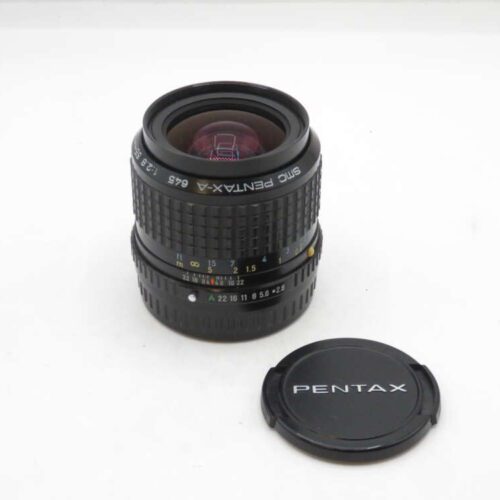 A Pentax-A 645 1:2.8 45mm camera lens with a detachable black lens cap beside it, placed on a plain white surface.