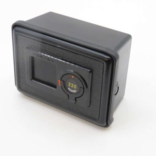 A black Pentax film back accessory featuring a rectangular shape and a circular dial indicating "220."