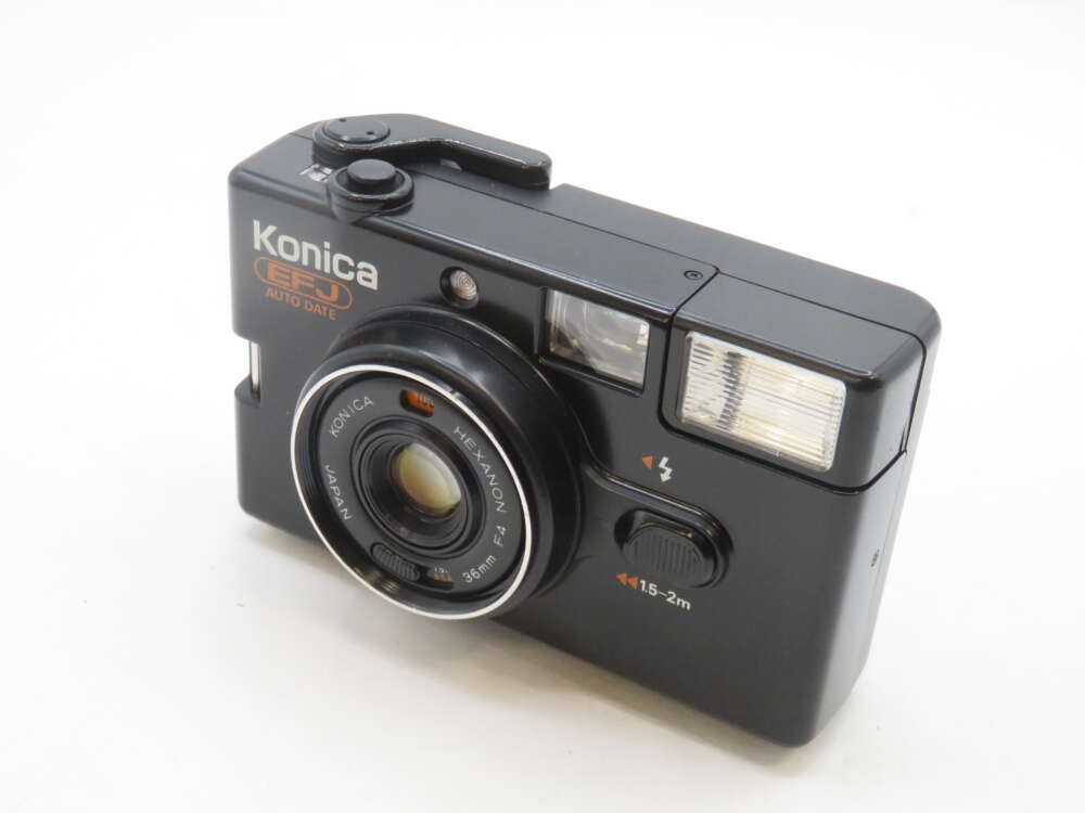 IMG_2186 A black Konica EFJ Auto Date point-and-shoot film camera with a lens labeled "Konica Hexanon 36mm f4" and a built-in flash on the front.