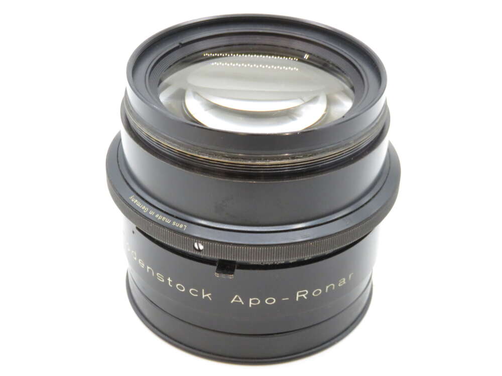 IMG_2230 A large-format camera lens labeled "Rodenstock Apo-Ronar," with a black metal body and clear glass elements, made in Germany.