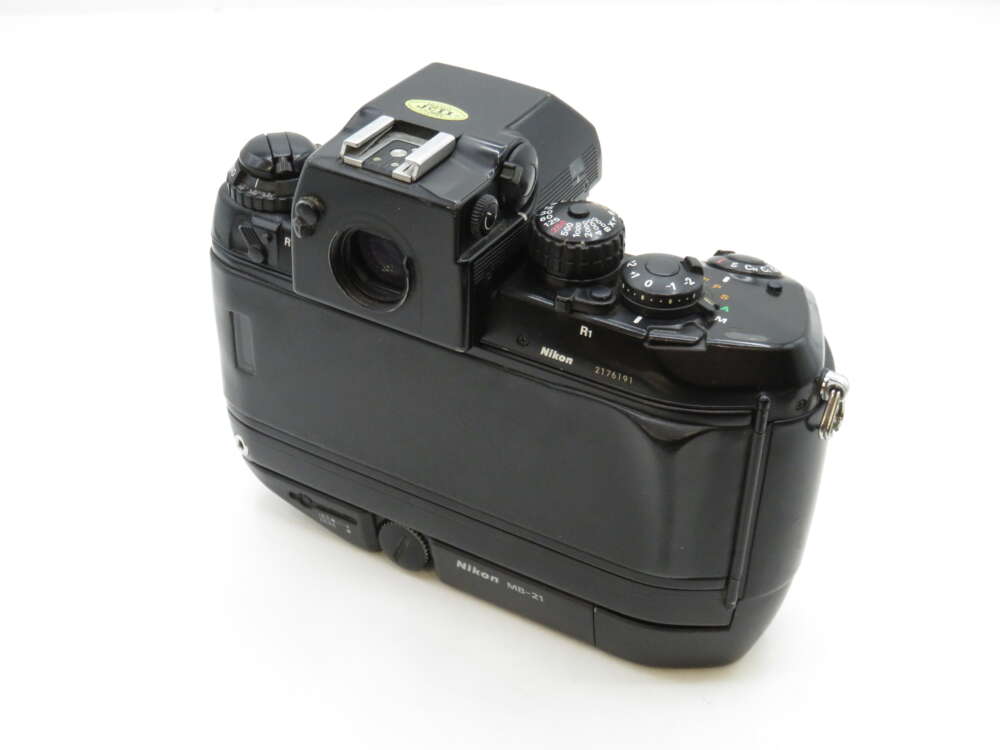 Rear view of a Nikon film camera showing control dials, viewfinder, and the model name R1 and MD-21 on the body.