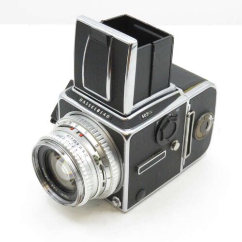 A vintage Hasselblad 500 C/M camera with a large viewfinder and silver lens, shown against a plain background.