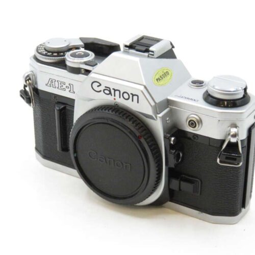 Vintage Canon AE-1 camera with a black and silver body and prominent branding on the front.