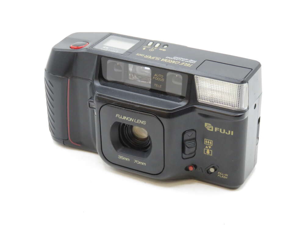 IMG_3184 A vintage Fuji camera with a wide lens, flash, and various control buttons.