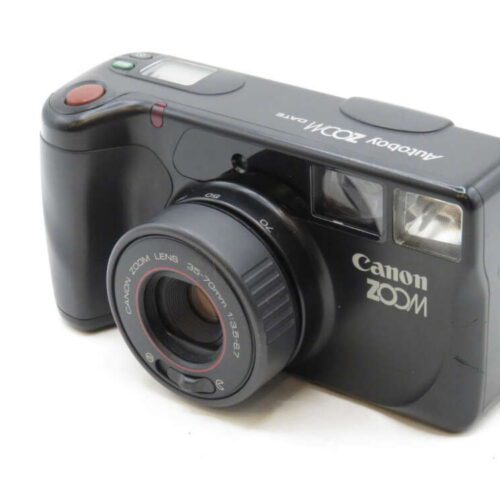A black Canon Autoboy Zoom QD lens camera with a prominent zoom lens and flash.