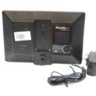 Back view of a Phottix Nuada light with power switch, barcode, and attached power adapter.