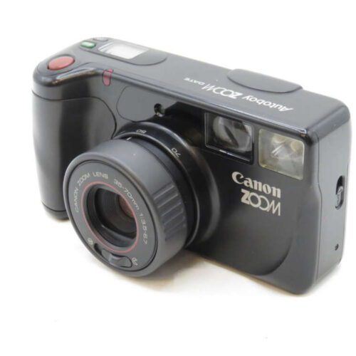 A black Canon zoom film camera with a lens and built-in flash.
