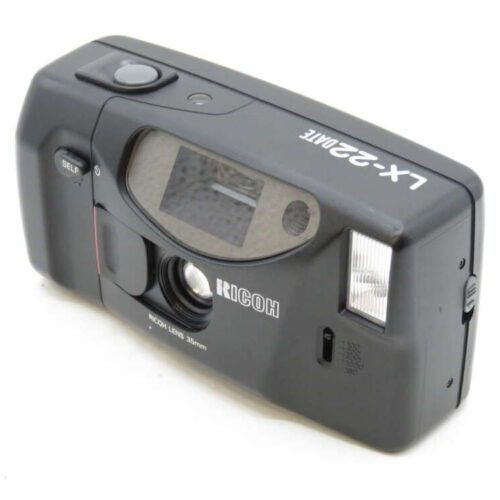 A black Ricoh LX-22 Date film camera with a built-in flash and a 32mm lens.