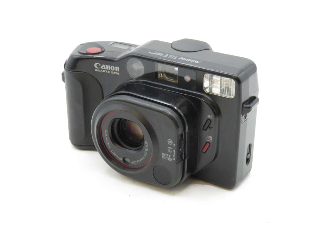 IMG_3245 A black Canon camera with a large lens and built-in flash, labelled as "Quartet Date" and "Tele Super".