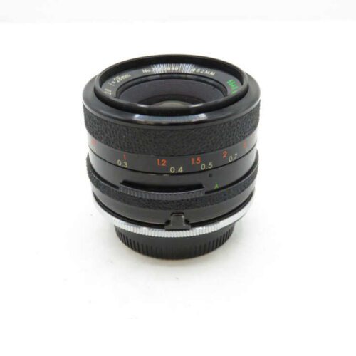 A black camera lens with distance markings, featuring a textured focus ring and metal mount.