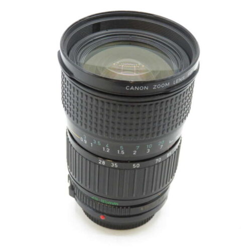 A Canon zoom lens with a textured focus ring and focal length markings.