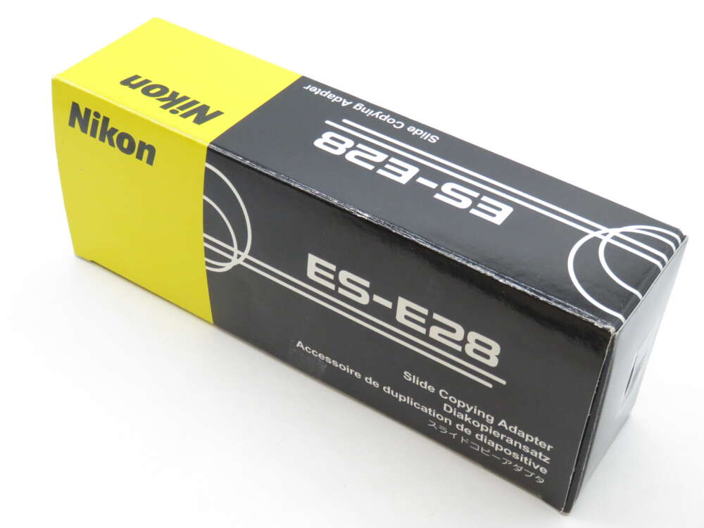 IMG_3383 Box of a Nikon ES-E28 Slide Copying Adapter with yellow and black design.