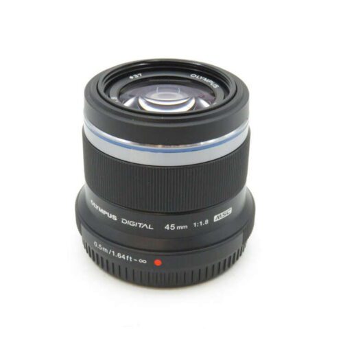 A black Olympus 45mm f/1.8 camera lens with white and silver details, shown on a white background.