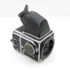 A vintage Hasselblad camera with a waist-level viewfinder and sleek black and silver finish.