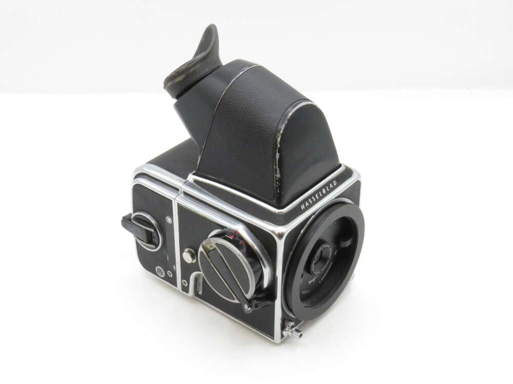 A vintage Hasselblad camera with a waist-level viewfinder and sleek black and silver finish.