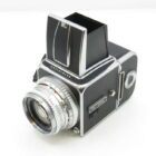 A vintage Hasselblad camera with a silver lens and waist-level viewfinder.