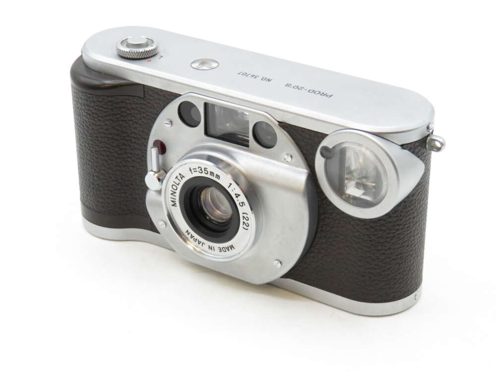 IMG_3551 A vintage Minolta film camera with a brown and silver body, featuring a prominent lens and a viewfinder.