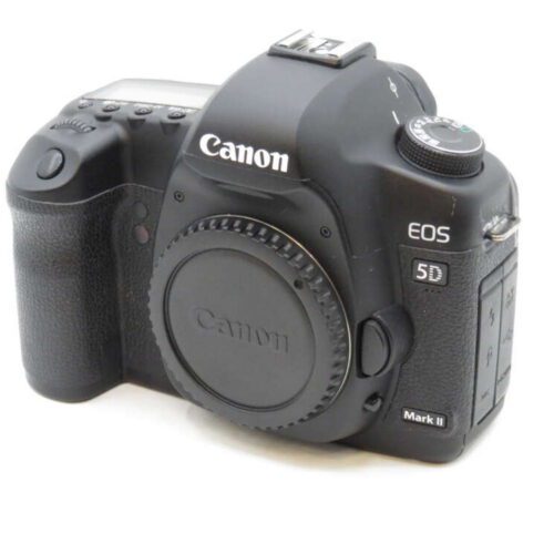 Black Canon EOS 5D Mark II camera body with a textured grip and a cap covering the lens mount.