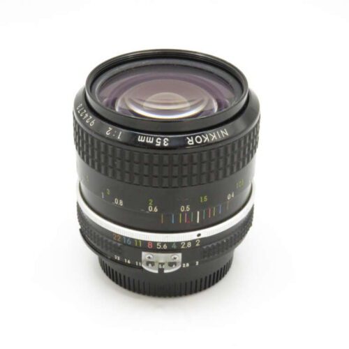 A Nikon 35mm lens with a focus ring, aperture markings, and engraved model details on a white background.