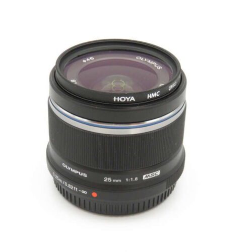 A black Olympus 25mm f/1.8 camera lens with a Hoya HMC UV filter attached.