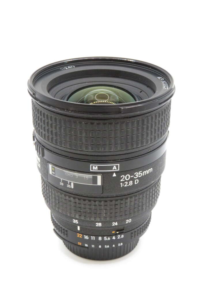 IMG_3760 Camera lens with "20-35mm 1:2.8 D" markings, featuring zoom and focus rings, against a white background.