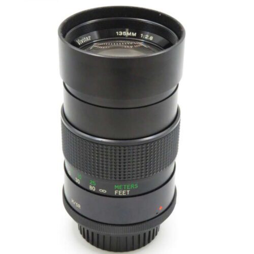 Camera lens with "Vivitar 135mm 1:2.8" printed on the front ring, featuring a textured focus ring and distance markings.