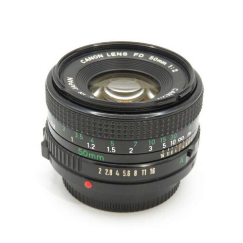 A Canon FD 50mm camera lens with focus and aperture rings, marked with f-stops from 1.2 to 16, viewed from the front.