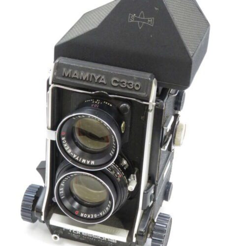 A vintage Mamiya C330 twin-lens reflex camera with two large lenses and a robust black body.