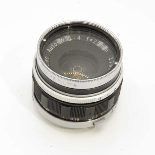 A vintage camera lens with a silver and black metal body, featuring engraved text indicating "Auto 1:1.1 f=28mm."