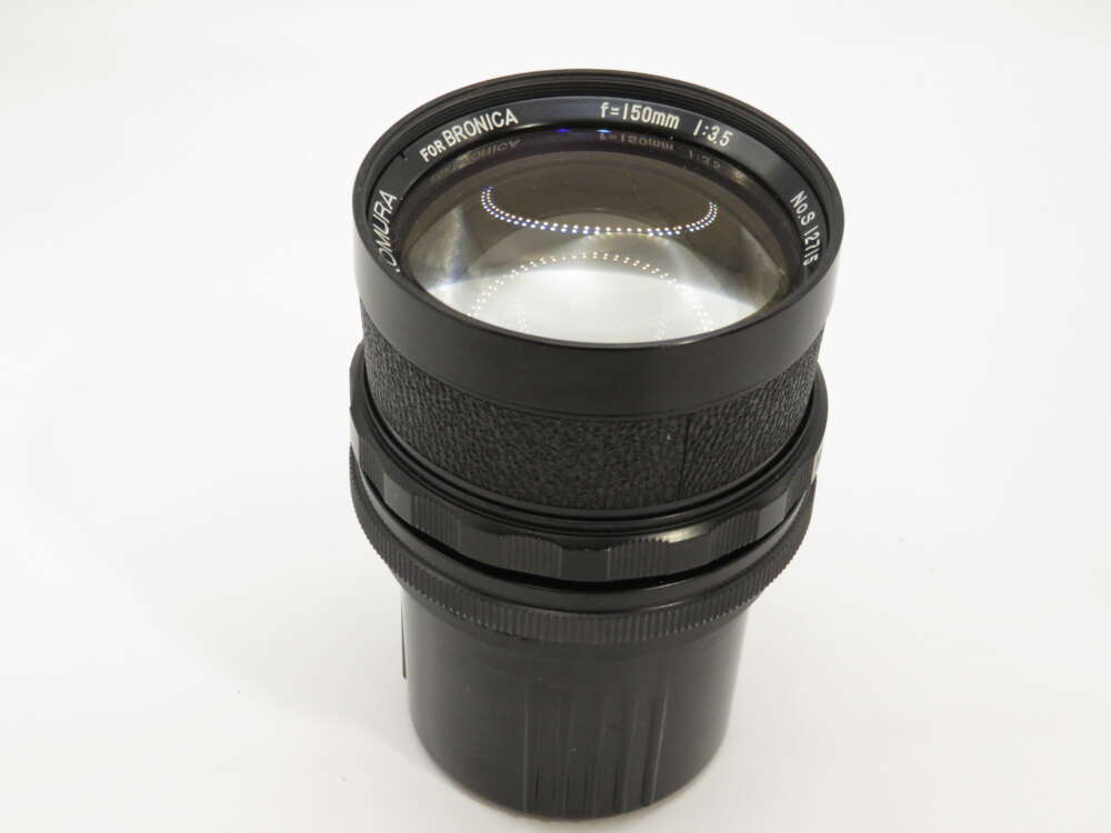 IMG_3896 A black Zenzanon camera lens marked "150mm f/3.5" with textured focus ring and clean glass.