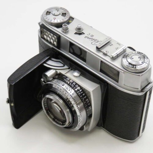 A vintage Voigtländer Vito CL camera with a black leatherette covering and extended lens, featuring dials and a classic design.