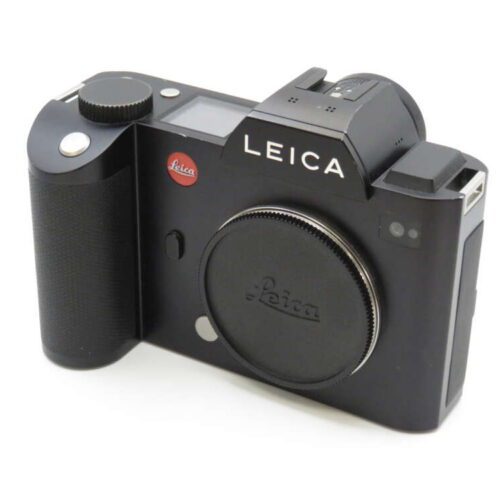 A black Leica camera with a textured grip and lens cap, featuring the Leica logo prominently displayed.