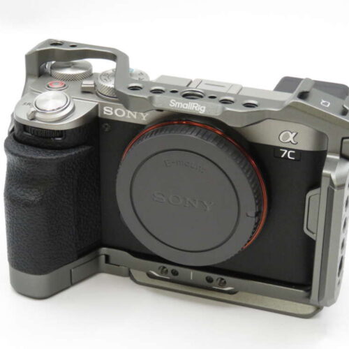 A Sony Alpha 7C mirrorless camera with a black body, metal grip, and protective SmallRig cage.