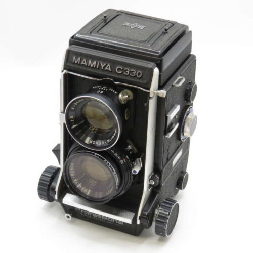 Mamiya C330 twin-lens reflex camera with a black body and two lenses, set against a plain white background.