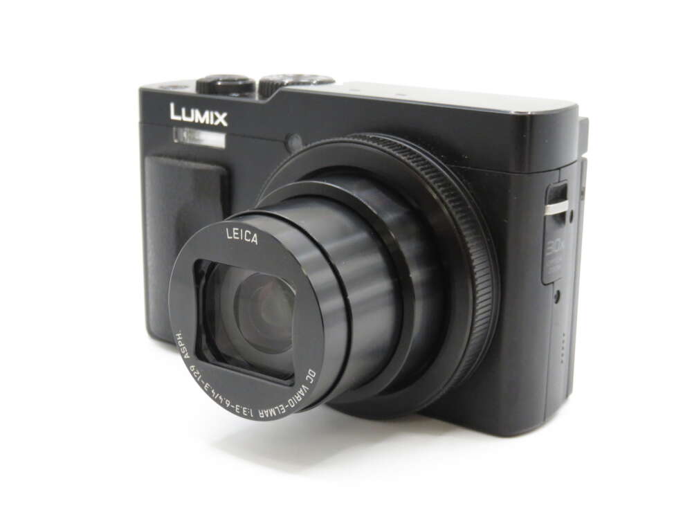IMG_4115 A black Lumix digital camera with an extended Leica lens, shown from an angled front view.