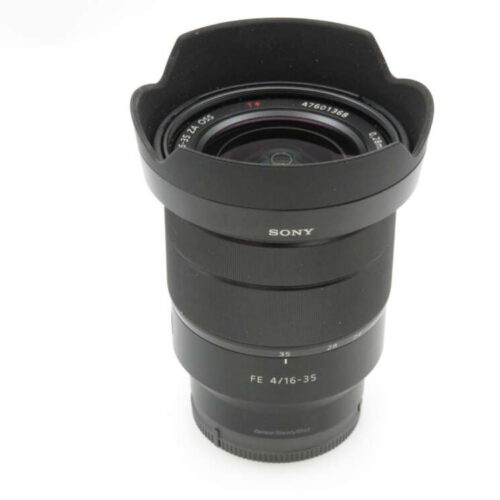 A black Sony camera lens with a 16-35mm focal length and f/4 aperture setting on a white background.