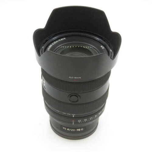 A camera lens with a lens hood, featuring visible labels like "FE 4/20-70 G" against a plain white background.