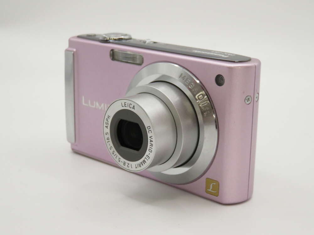 IMG_4181 A pink digital camera with a Leica lens and various controls on its body.