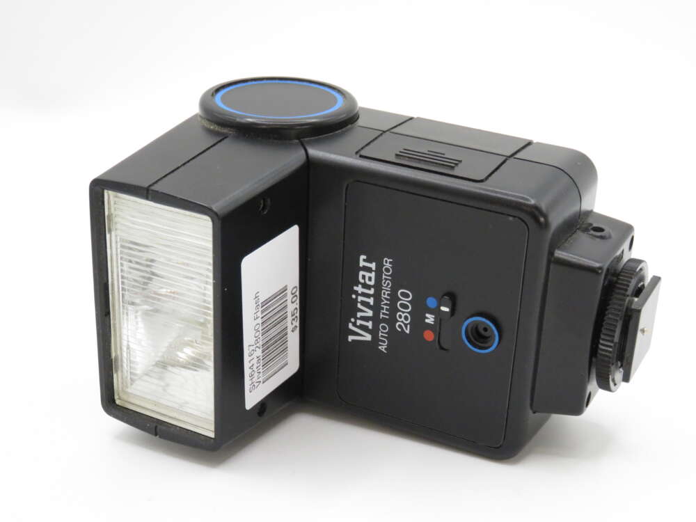 IMG_4189 A vintage Vivitar Auto Thyristor 2800 flash unit with a rectangular flash head and control buttons on the side.
