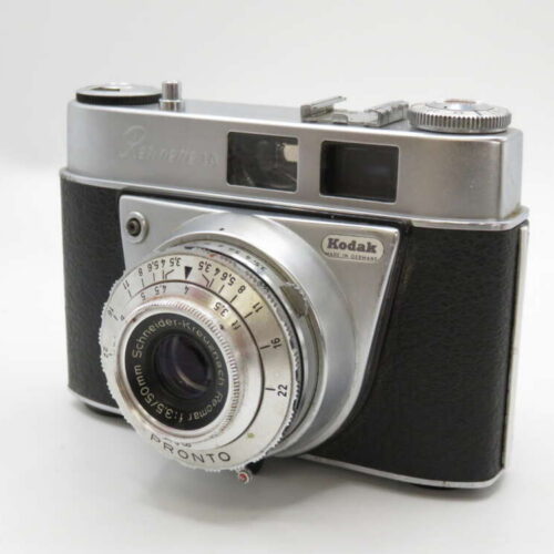 A vintage Kodak Retina camera with a black and silver body and a prominent lens.