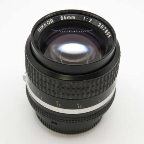 A Nikon Nikkor 85mm f/2 lens with a textured focus ring and aperture markings.