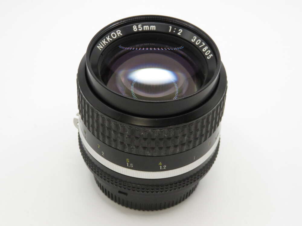 IMG_4219 A Nikon Nikkor 85mm f/2 lens with a textured focus ring and aperture markings.