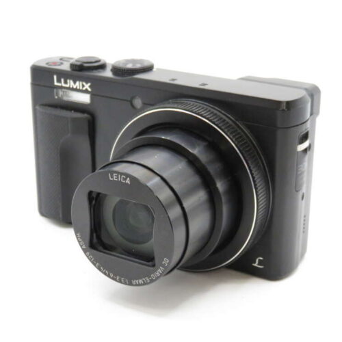 A black Lumix digital camera with an extended Leica lens on a white background.
