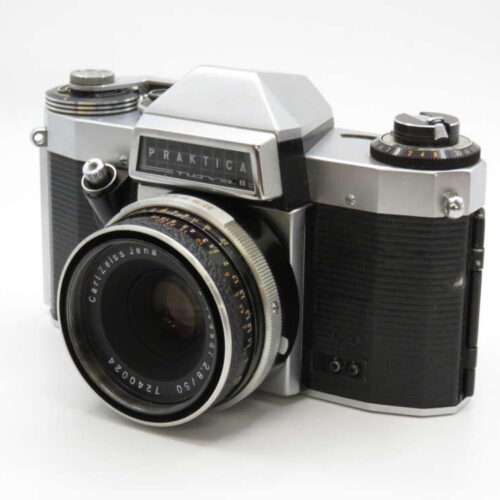A vintage Praktica film camera with a Carl Zeiss Jena lens on a white background.