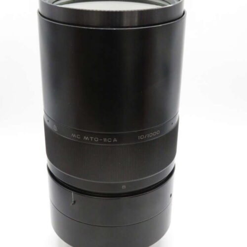 A black camera lens with the model MC MTO-11CA 10/1000 marked on it.